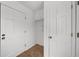 Hallway featuring white walls and doors, tiled floor and overhead cabinet at 1655 Pine Ridge Cir, Woodstock, GA 30188