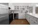 Updated kitchen with white cabinets, tile backsplash, and stainless steel appliances at 1655 Pine Ridge Cir, Woodstock, GA 30188