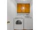 Laundry room with full-size washer and dryer and cabinetry at 1655 Pine Ridge Cir, Woodstock, GA 30188