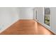 Bright, airy room with hardwood floors, large windows, and neutral wall paint at 1655 Pine Ridge Cir, Woodstock, GA 30188