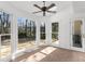 Bright sunroom with tiled floors, and large windows overlooking the backyard at 1655 Pine Ridge Cir, Woodstock, GA 30188