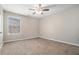 Bedroom with plush carpet, ceiling fan, and natural light from the window at 3272 Tiara Sw Cir, Atlanta, GA 30311