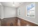 Bright bedroom with hardwood floors and abundant natural light from two windows, creating a cozy atmosphere at 3272 Tiara Sw Cir, Atlanta, GA 30311