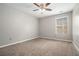 Bedroom with plush carpet, ceiling fan, and natural light from the window at 3272 Tiara Sw Cir, Atlanta, GA 30311