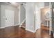 Inviting entryway with hardwood floors, staircase, and access to a powder room, providing a warm welcome at 3272 Tiara Sw Cir, Atlanta, GA 30311