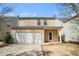 Exterior view of home with two-car garage, tan siding, and neutral-colored trim at 3272 Tiara Sw Cir, Atlanta, GA 30311
