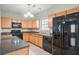 Well-equipped kitchen with stainless steel appliances, granite countertops, and ample cabinet space at 3272 Tiara Sw Cir, Atlanta, GA 30311