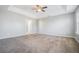 Bright main bedroom featuring a ceiling fan and plush carpet at 3272 Tiara Sw Cir, Atlanta, GA 30311