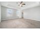 Spacious main bedroom featuring a tray ceiling with fan and plush carpet at 3272 Tiara Sw Cir, Atlanta, GA 30311