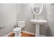 Elegant powder room featuring a pedestal sink, toilet, and stylish fixtures, designed for convenience at 3272 Tiara Sw Cir, Atlanta, GA 30311