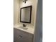 Modern bathroom features a sleek vanity with a black faucet and a stylish light fixture at 5447 Blossomwood Sw Trl, Mableton, GA 30126