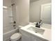 Bright bathroom with a tub-shower combination, white vanity, and dark fixtures at 5447 Blossomwood Sw Trl, Mableton, GA 30126