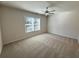 Bedroom with neutral walls, ceiling fan, and window at 5447 Blossomwood Sw Trl, Mableton, GA 30126