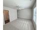 Bedroom features neutral walls, a ceiling fan, a large window, and an attached closet at 5447 Blossomwood Sw Trl, Mableton, GA 30126