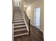 Elegant hallway with hardwood floors, staircase and white trim, leading to the main areas of the home at 5447 Blossomwood Sw Trl, Mableton, GA 30126