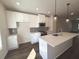 Modern kitchen with white cabinetry, stainless steel appliances, island with sink and pendant lighting at 5447 Blossomwood Sw Trl, Mableton, GA 30126