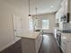 Bright kitchen with a central island, modern appliances, white cabinetry, and stylish pendant lights at 5447 Blossomwood Sw Trl, Mableton, GA 30126
