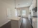 Modern kitchen with a central island, stainless steel appliances, and elegant pendant lights at 5447 Blossomwood Sw Trl, Mableton, GA 30126