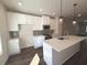 Well-lit kitchen with white cabinetry, stainless steel appliances, and a center island at 5447 Blossomwood Sw Trl, Mableton, GA 30126