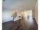 Spacious open-plan living area with hardwood floors, a contemporary fireplace, and staircase at 5447 Blossomwood Sw Trl, Mableton, GA 30126