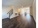 Spacious living room with dark hardwood floors, staircase, and open layout to the kitchen at 5447 Blossomwood Sw Trl, Mableton, GA 30126