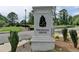 Entrance to Magnolia Grove community with manicured landscaping at 5447 Blossomwood Sw Trl, Mableton, GA 30126