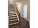 Elegant staircase featuring wood and white trim, leading to the upper level at 5447 Blossomwood Sw Trl, Mableton, GA 30126