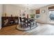 Dining room with modern chandelier, table with seating for four, and a view of the backyard at 599 Collections Dr, Lawrenceville, GA 30043