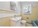 Cozy bathroom with yellow tile, updated sink and vanity, toilet, tub and bright window at 3035 Mclendon Nw Cir, Atlanta, GA 30318