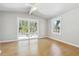 An airy bedroom features a vaulted ceiling, expansive windows offering serene outdoor views, and hardwood floors at 3035 Mclendon Nw Cir, Atlanta, GA 30318