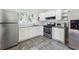 Well-lit kitchen features stainless steel appliances, granite countertops, white cabinetry and a window with a green outdoor view at 3035 Mclendon Nw Cir, Atlanta, GA 30318