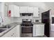 A well-equipped kitchen featuring stainless steel appliances and white cabinets, complemented by granite countertops at 3035 Mclendon Nw Cir, Atlanta, GA 30318