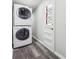 Efficient laundry room with stacked washer and dryer, plus a door to the backyard at 3035 Mclendon Nw Cir, Atlanta, GA 30318