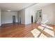 Open concept living area showcasing gleaming hardwood floors and a staircase leading to the upper level at 3035 Mclendon Nw Cir, Atlanta, GA 30318