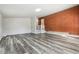 Living area showcases wood-look floors and a striking brick accent wall, creating a warm and inviting atmosphere at 3035 Mclendon Nw Cir, Atlanta, GA 30318