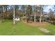 Home's lush backyard features a small storage shed surrounded by tall trees at 322 Foxfire Sw Dr, Smyrna, GA 30082