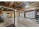 Unfinished basement space with exposed ceiling and garage doors at 322 Foxfire Sw Dr, Smyrna, GA 30082