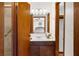 Bathroom featuring a well-lit vanity with dark wood cabinets and a large mirror at 322 Foxfire Sw Dr, Smyrna, GA 30082