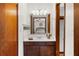 Bathroom featuring a well-lit vanity with dark wood cabinets and a large mirror at 322 Foxfire Sw Dr, Smyrna, GA 30082