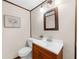 Well-lit half bathroom featuring vanity with sink, framed mirror and decorative elements at 322 Foxfire Sw Dr, Smyrna, GA 30082