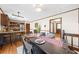 Dining room view with wood floors, seating for six, and open layout to kitchen and entry at 322 Foxfire Sw Dr, Smyrna, GA 30082