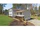 A beautiful home featuring a covered front porch, two-car garage, and professionally landscaped yard at 322 Foxfire Sw Dr, Smyrna, GA 30082
