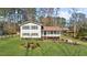 A well-kept home with green shutters, a covered porch, and a beautifully landscaped front yard at 322 Foxfire Sw Dr, Smyrna, GA 30082