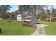 Well-manicured lawn with a charming home featuring a covered porch and two-car garage at 322 Foxfire Sw Dr, Smyrna, GA 30082