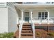 Close-up of the front porch with a painted door and white railings at 322 Foxfire Sw Dr, Smyrna, GA 30082