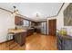 Kitchen featuring stainless steel appliances, breakfast bar, wood cabinets, and wooden floors at 322 Foxfire Sw Dr, Smyrna, GA 30082