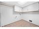 Spacious laundry room with tile floors and wall cabinets at 322 Foxfire Sw Dr, Smyrna, GA 30082