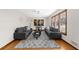 Cozy living room with modern sofas, a patterned rug, and warm lighting at 322 Foxfire Sw Dr, Smyrna, GA 30082