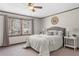 Comfortable main bedroom featuring a ceiling fan and a large window allowing plenty of natural light at 322 Foxfire Sw Dr, Smyrna, GA 30082