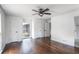 Bedroom features wood floors, neutral paint, and a ceiling fan with bright natural light at 3280 Hazelwood Sw Dr, Atlanta, GA 30311